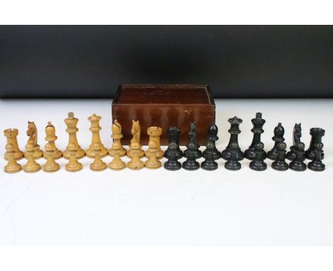 A set of early 20th century boxwood chess pieces within wooden box.