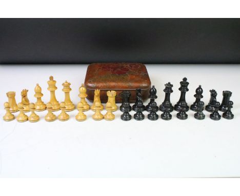 A set of early 20th century boxwood chess pieces within a Huntley &amp; Palmers biscuit tin.