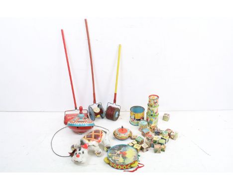 A small collection of vintage toys to include tin plate spinning top, roller toys, wooden blocks and tin plate dog. 