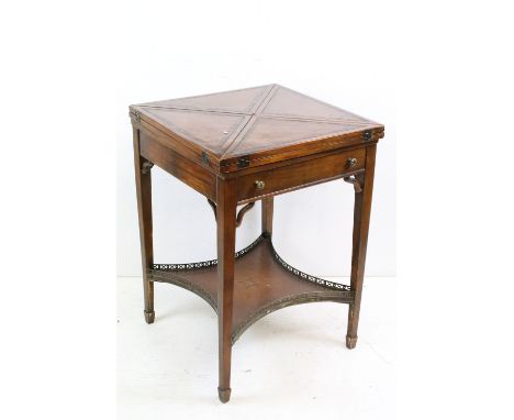 Edwardian Mahogany Envelope Card Table, the four brown leather inset flaps opening to a playing surface, the interior of the 