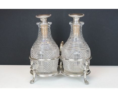 19th Century silver plated decanter stand having Egyptian revival detailing having two cut glass decanters with silver plated