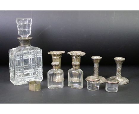 A collection of mixed sterling silver to include a pair of bud vases, pair of candlesticks, vanity jars, napkin ring and a si