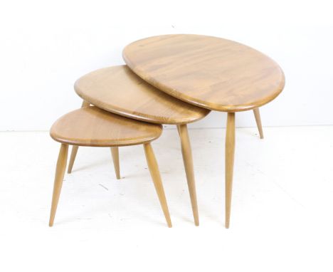 Ercol Pale Elm and Beech Nest of Three Pebble Tables, model 354, 65cm long x 41cm high 