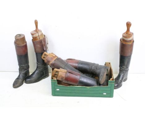 A group of three pairs of vintage leather riding boots complete with wooden trees. 