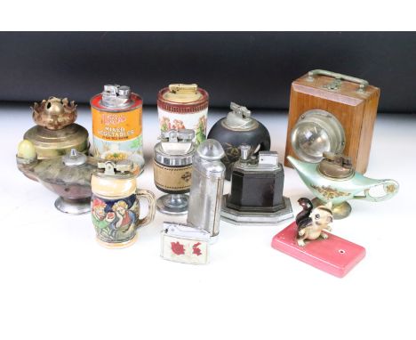A large collection of vintage and contemporary pocket and table lighters together with wooden ever-ready torches and a storm 