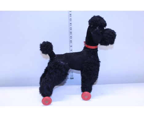 A vintage 1960's pull along toy Poodle 