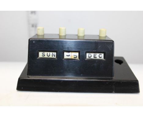 A vintage Bakelite perpetual calendar (missing pen) 