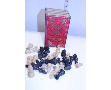 A vintage biscuit tin and wooden chess set 