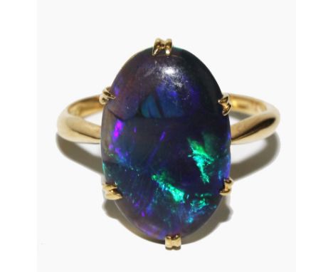 A fine quality 18 carat gold ring set with an oval black opal