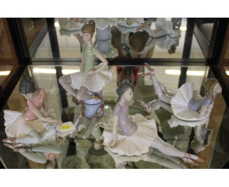 A selection of four Lladro figurines of young ballerinas coloured costumes 