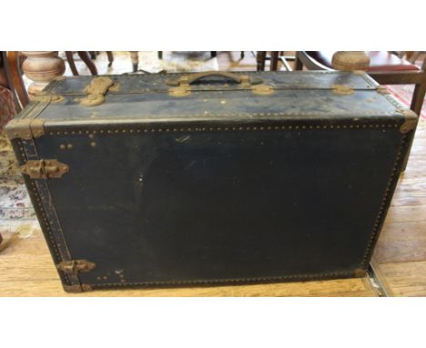 An early 20th century oblong metal travelling trunk with metal fittings and leather handles, 86cm wide