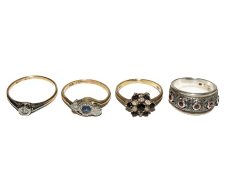 A three stone sapphire ring, a sapphire and paste ring and a single stone diamond ring