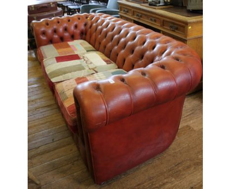 A vintage Chesterfield red leather upholstered button back three seat sofa on castors, 200cm wide 