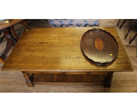 A 19th century-style light oak stained coffee table of oblong form with shaped top, two drawers under, raised on baluster sha