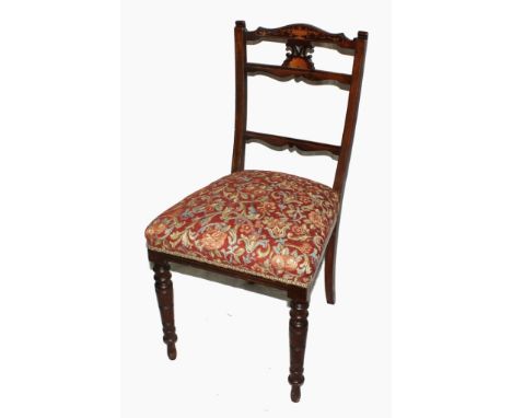 An Edwardian mahogany drawing room suite, comprising two armchairs and three side chairs with overall inlay, arched top rails