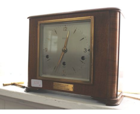 An Art Deco walnut framed mantle clock with square dial, Arabic numerals, by W. W. Perry and Co, Birmingham, presented to Joy