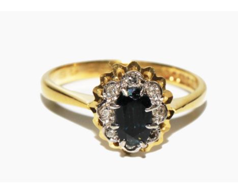 An 18 carat gold sapphire and diamond cluster ring 