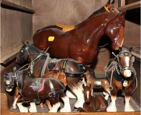 A broad assortment of ceramic figurines of horses, to include a Clydesdale and foals
