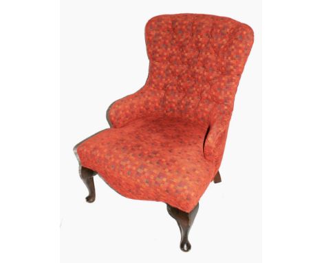 A Victorian mahogany framed fabric upholstered lady's chair with button back support, carved arms, serpentine fronted, raised