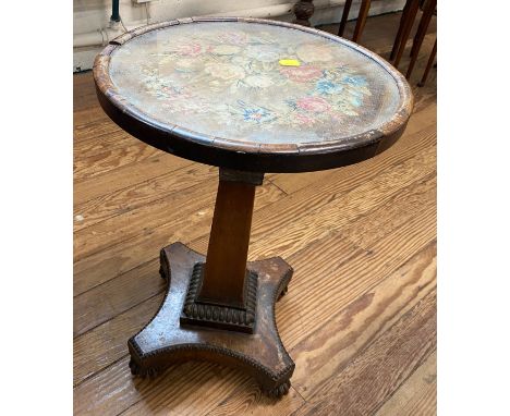 An early 19th century Occasional Table. with tapestry top and platform base. In need of restoration. 52cm x 36.5cm diameter 