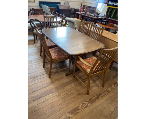 A Modern teak Ercol Style Dining Room Suite. Comprising a dining table and six chairs 