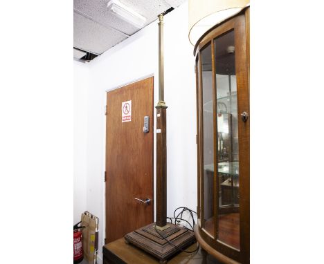 A BRASS AND OAK STANDARD LAMP, THE SQUARE COLUMN RAISED ON STEPPED BASE 