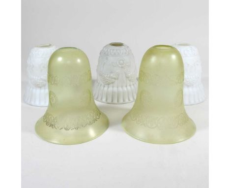 Three opaque white glass light shades, together with a pair of green etched glass shades, 15cm high (5)