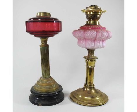 A pink oil lamp base, 43cm high, together with an oil lamp base with a ruby glass font (2)Ruby glass font has drilled hole