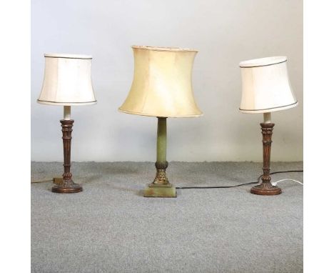 A pair of gilt painted table lamps and shades, together with a brass mounted green onyx table lamp and shade, 63cm high overa