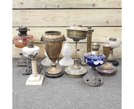 A collection of various oil lamp bases, highest 37cm