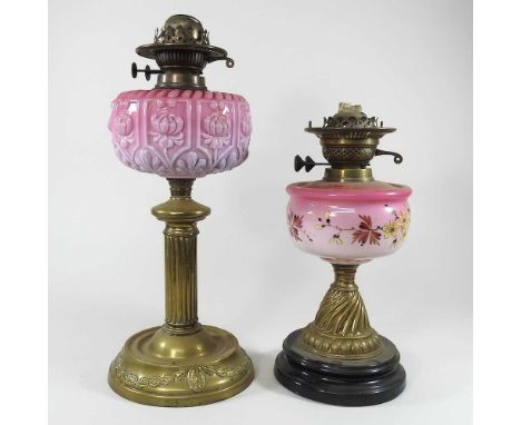 Two brass oil lamp bases, with pink glass fonts, highest 47cm (2)