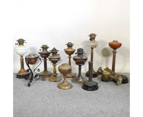 A collection of eleven oil lamp bases, various designs (11)