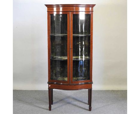 An Edwardian mahogany and inlaid serpentine display cabinet, on square legs78w x 45d x 170h cmOverall solid and usable, no ob