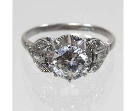 An antique platinum set diamond ring, the central stone approximately 1.5 carats, with diamond set shoulders, size P, 4.5g gr