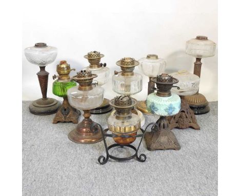 A collection of ten mostly 19th and early 20th century oil lamp bases, with glass fonts, various designs (10)