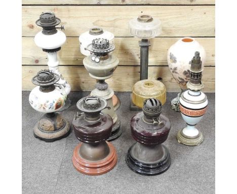 A collection of oil lamp bases, highest 49cm
