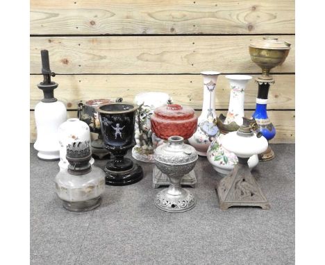 A collection of oil lamp bases, highest 46cm