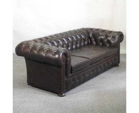 A brown upholstered button back chesterfield sofa, mid 20th century, on turned feet208w x 94d x 68h cmOverall is usable, but 
