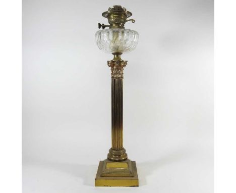 A 19th century brass Corinthian column oil lamp, with a clear cut glass reservoir, 67cm high overall