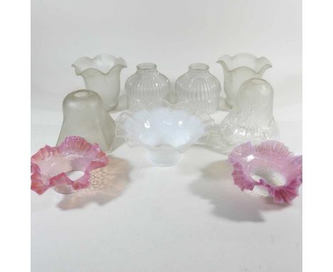 A collection of glass lamp shades, to include two pink shades with frilled edge, 15cm diameter