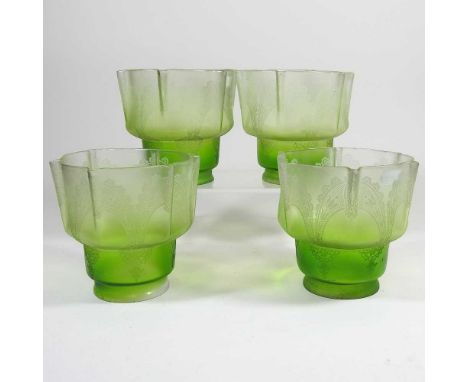 Four green etched glass light shades, 12cm highOverall dirty with light surface marks, one has a small chip to the edge, some