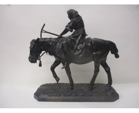 A late 19th century patinated cast metal model of a woman carrying a rake on a horse, on a naturalistic base, 16 1/2" h 