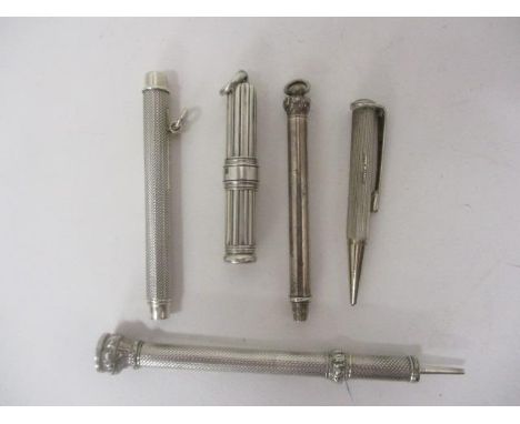 Four silver and white metal cased propelling pencils, two by Sampson Mordan & Co with engine turned, embossed and reeded orna