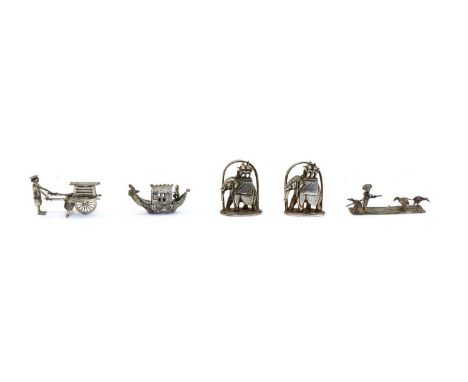 A small late 19th century Chinese silver model of an oriental, on a raft with herons; a small Dutch silver boat, 19th century