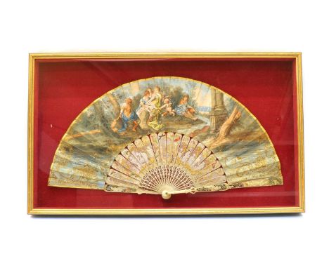 An 18th century ivory and hand painted fan, decorated with figures and a putto in classical dress within a landscape scene an