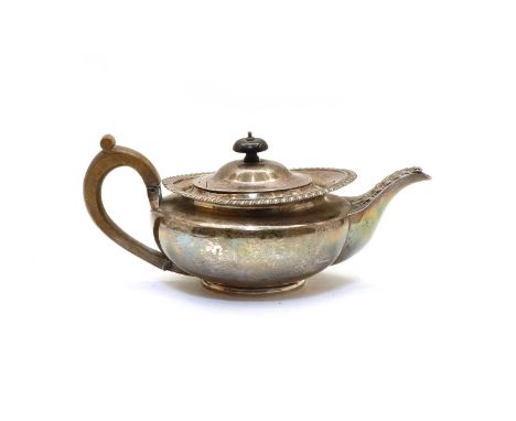 A silver teapot, by Rebecca Emes &amp; Edward Barnard, 1821, of squat form, with a gadrooned edge, with leaf detail to the sp
