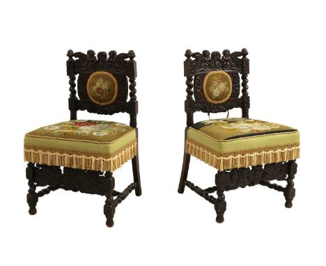 A pair of 19th century carved walnut chairs, in Carolean style, with overstuffed tapestry seats. 87cm high, 52cm wide, 45cm d