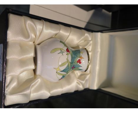 A Moorcroft enamel mistletoe and holly vase, initialled J.O.T. 6.5cm high in original box