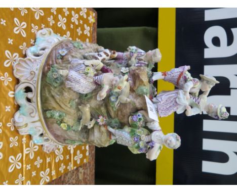 A Meissen figure group of children among rabbits and a dog on an anthemion and scroll base, some repairs, crossed sword and p