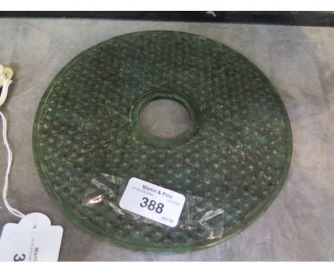 A dark green jade/ Nephrite bi-disc with dimpled surface on both sides 19cm diameter